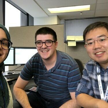 From left: Developers talk development — Code for Canada fellow Fatima, with Josh and Weiguang from TC.